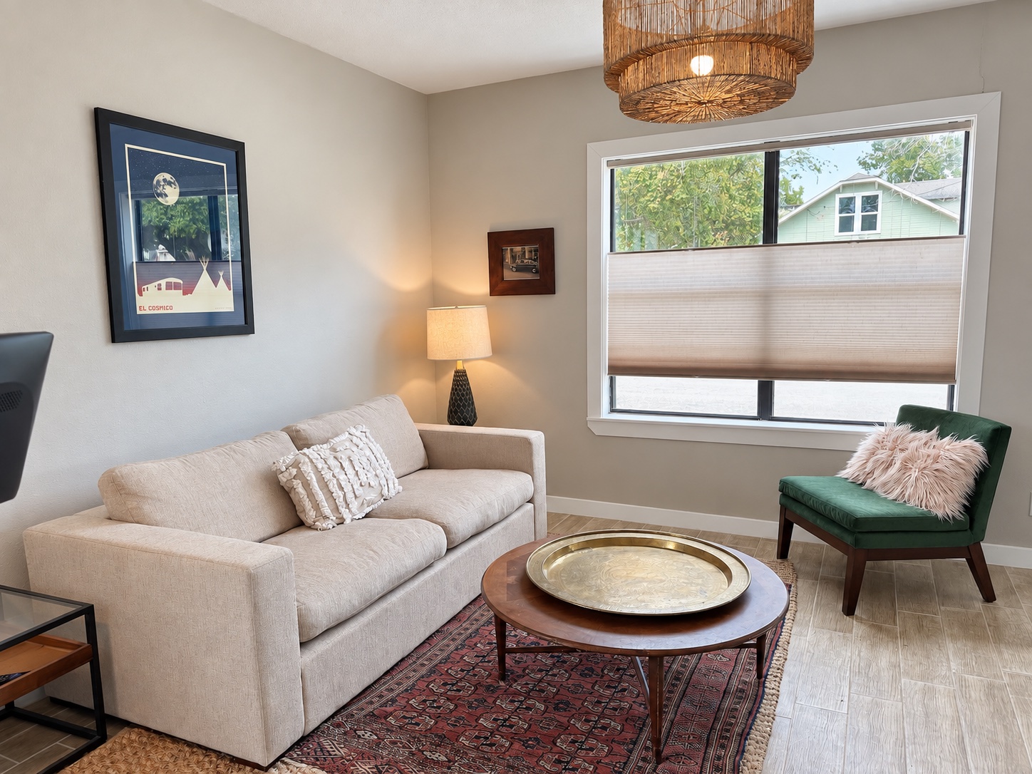 Collected textures, vintage rug and green velvet chair in the Main House living room