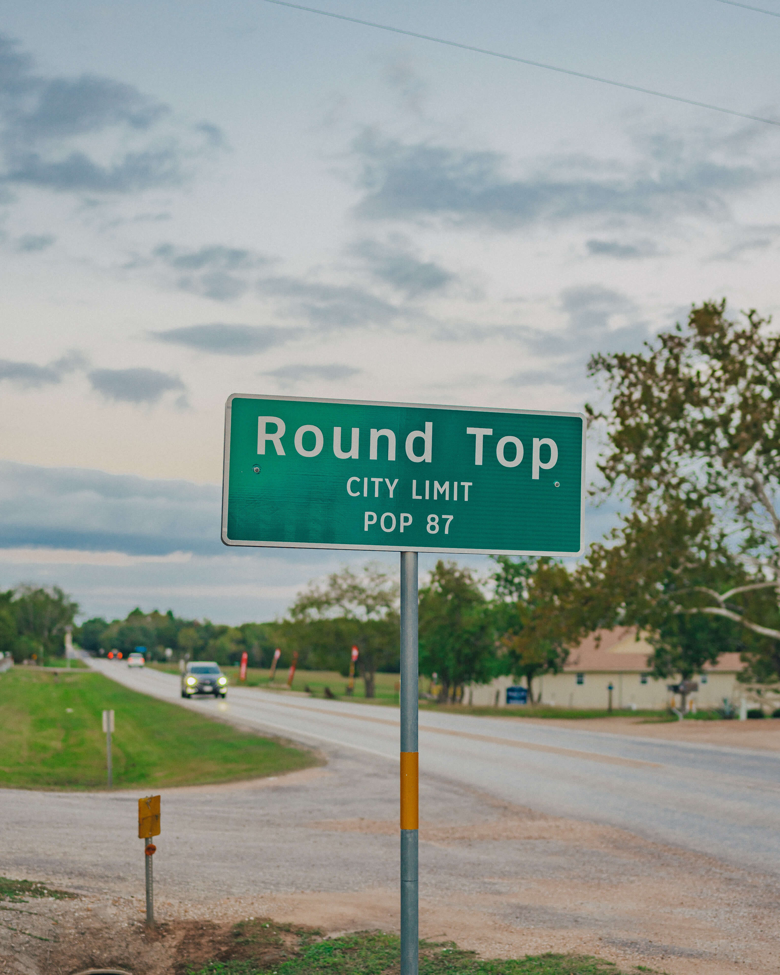 Round Top city-limit sign on a country road