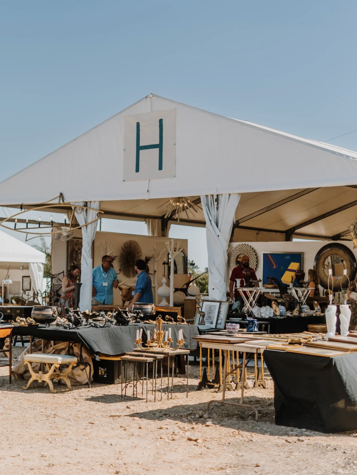 Vintage furniture, mirrors and decorative finds under a Round Top antiques tent